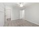 This bedroom includes neutral walls, carpeted floors, a ceiling fan, and access to a closet at 2309 Filigree Ct, Raleigh, NC 27614