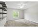 This is a bedroom with neutral walls, carpeted floors, a ceiling fan, a window, and shelving at 2309 Filigree Ct, Raleigh, NC 27614