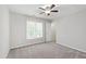 Bedroom featuring a ceiling fan, a window, and neutral color carpet at 2309 Filigree Ct, Raleigh, NC 27614