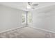 A bedroom with neutral walls, carpeted floors, a ceiling fan, and two windows for natural light at 2309 Filigree Ct, Raleigh, NC 27614