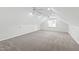 The bonus room features carpeted floors, white walls and trim, and natural light from a window at 2309 Filigree Ct, Raleigh, NC 27614
