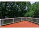 Exterior shot of the stained deck overlooking a lush wooded area at 2309 Filigree Ct, Raleigh, NC 27614