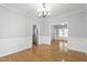 Formal dining room showcasing hardwood floors, wainscoting, and an elegant chandelier at 2309 Filigree Ct, Raleigh, NC 27614