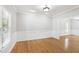 Bright dining room featuring hardwood floors, large windows, and elegant wainscoting detail at 2309 Filigree Ct, Raleigh, NC 27614