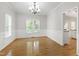 Dining room with hardwood floors, wainscoting, and a bright window view at 2309 Filigree Ct, Raleigh, NC 27614