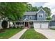 Charming two-story home with a well-manicured lawn, large front porch, and a two-car garage at 2309 Filigree Ct, Raleigh, NC 27614