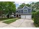 Charming two-story blue home featuring a two-car garage and a welcoming front porch at 2309 Filigree Ct, Raleigh, NC 27614