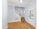 Bright foyer featuring hardwood floors, a staircase, and a front door that lets in natural light at 2309 Filigree Ct, Raleigh, NC 27614
