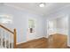 Bright foyer featuring hardwood floors, a staircase, and a view into other rooms at 2309 Filigree Ct, Raleigh, NC 27614