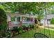 Inviting front porch with a swing, ceiling fans, white railings, and landscaped garden beds at 2309 Filigree Ct, Raleigh, NC 27614