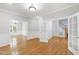 Spacious living room with hardwood floors, large windows, and elegant wainscoting for a bright, airy feel at 2309 Filigree Ct, Raleigh, NC 27614