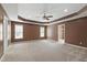 Spacious main bedroom with a tray ceiling, ceiling fan, and two windows at 2309 Filigree Ct, Raleigh, NC 27614