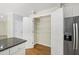 Walk-in pantry with white shelving and stainless steel refrigerator at 2309 Filigree Ct, Raleigh, NC 27614