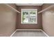 Walk-in closet with carpeted floor, wire shelving, and a window with a view at 2309 Filigree Ct, Raleigh, NC 27614