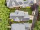 An aerial view of the home showcasing the lush green yard and stone patio at 2309 Yancey St, Raleigh, NC 27608