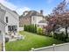 Well-manicured backyard showcasing a lush lawn, patio seating, and mature trees at 2309 Yancey St, Raleigh, NC 27608