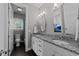 Well-lit bathroom featuring a double sink vanity with granite counters and a shower-tub combination at 2309 Yancey St, Raleigh, NC 27608
