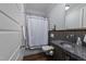 Updated bathroom with a granite countertop, subway tile backsplash, and tub-shower combination at 2309 Yancey St, Raleigh, NC 27608