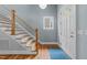 Bright entryway showcasing a modern staircase, hardwood floors, and a stylish front door at 2309 Yancey St, Raleigh, NC 27608
