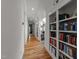 Hallway features hardwood floors, built-in bookshelves and lots of natural light at 2309 Yancey St, Raleigh, NC 27608
