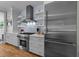 Modern kitchen featuring stainless steel appliances, light blue backsplash, and open shelving at 2309 Yancey St, Raleigh, NC 27608