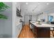 Spacious eat-in kitchen showcasing a large island with seating, pendant lighting, and hardwood floors at 2309 Yancey St, Raleigh, NC 27608