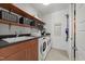 Laundry room includes new washer and dryer, sink, and overhead storage at 2309 Yancey St, Raleigh, NC 27608
