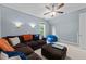 Spacious media room with window, brown couch and a beanbag chair at 2309 Yancey St, Raleigh, NC 27608