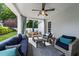 Inviting covered patio with comfortable seating, a ceiling fan, and a view of the manicured backyard at 2309 Yancey St, Raleigh, NC 27608