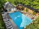 Community pool with lounge chairs, clear blue water, brick wall surround, and lush greenery at 2309 Yancey St, Raleigh, NC 27608
