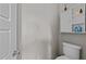 Clean half bathroom with white toilet and wall-mounted storage cabinet at 2309 Yancey St, Raleigh, NC 27608