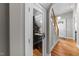 Hallway view of an enclosed custom wine cellar with glassware and wine storage at 2309 Yancey St, Raleigh, NC 27608