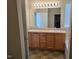 Bathroom featuring a double vanity, a large mirror, and tiled floors at 2330 Lazy River Dr, Raleigh, NC 27610