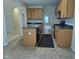 Well-lit kitchen boasts wooden cabinetry, black countertops, and modern appliances at 2330 Lazy River Dr, Raleigh, NC 27610