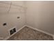 A cozy laundry room featuring a tile floor, wire shelving, and hookups at 2330 Lazy River Dr, Raleigh, NC 27610