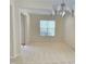 Bright living room featuring neutral carpet, an open floor plan, and natural light at 2330 Lazy River Dr, Raleigh, NC 27610
