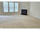This living room has lots of natural light, a fireplace, and neutral carpet at 2330 Lazy River Dr, Raleigh, NC 27610
