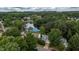 Wide aerial view of homes surrounding a lake at 2441 Deanwood Dr, Raleigh, NC 27615