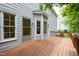 Wooden backyard deck wraps around a gray home with white trim at 2441 Deanwood Dr, Raleigh, NC 27615