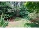 A view from a backyard deck of a yard with plenty of mature shade trees and other greenery at 2441 Deanwood Dr, Raleigh, NC 27615