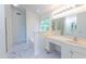 Bright bathroom with marble floors, dual sink vanity, and separate tub and shower at 2441 Deanwood Dr, Raleigh, NC 27615