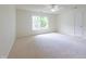 Bright bedroom features neutral carpet, ceiling fan, and a double window that provides plenty of natural light at 2441 Deanwood Dr, Raleigh, NC 27615