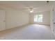 Spacious bedroom features neutral carpet, bright window, and white door at 2441 Deanwood Dr, Raleigh, NC 27615
