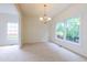 Inviting dining room featuring elegant chandelier lighting and large windows, perfect for Gathering meals at 2441 Deanwood Dr, Raleigh, NC 27615