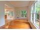 Bright dining area featuring hardwood floors, large windows, and seamless connection to kitchen at 2441 Deanwood Dr, Raleigh, NC 27615