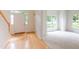Welcoming entryway with hardwood floors, staircase, and abundant natural light from adjacent rooms at 2441 Deanwood Dr, Raleigh, NC 27615