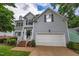 Front view of a gray home, garage, and porch with stairs at 2441 Deanwood Dr, Raleigh, NC 27615