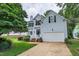 Charming home featuring a two-car garage, landscaped yard, and a welcoming front porch at 2441 Deanwood Dr, Raleigh, NC 27615