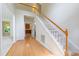 Grand foyer with hardwood floors, staircase, and views into the kitchen and dining areas at 2441 Deanwood Dr, Raleigh, NC 27615