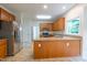 Open kitchen design with granite countertops, stainless steel fridge, and ample counter space at 2441 Deanwood Dr, Raleigh, NC 27615